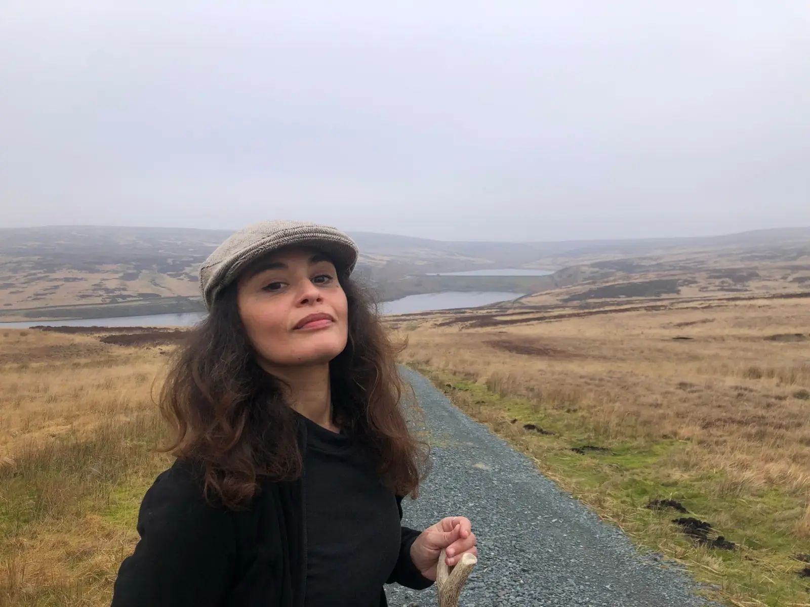 Ines in a tweed cap, looking into the camera