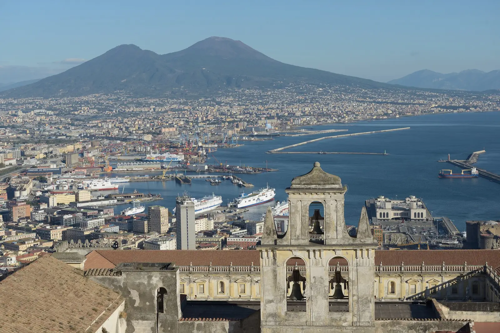 The Bay of Naples and Vesuvius, seen from above the city with the bell tower of San Martino in front