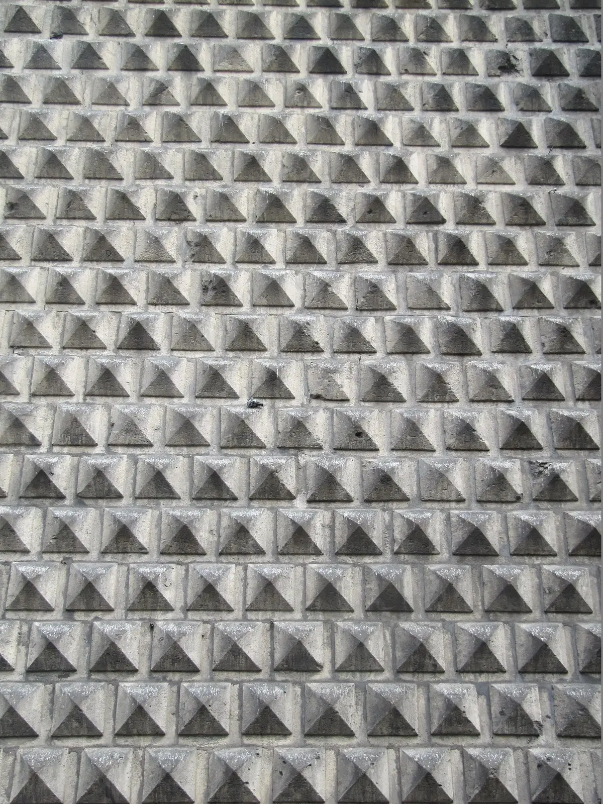 Close-up of the grey pyramid-shaped stones covering the facade of the Gesù Nuovo